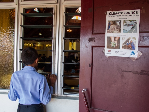 Boy and climate change poster at Catholic Church in Nuka' alofa