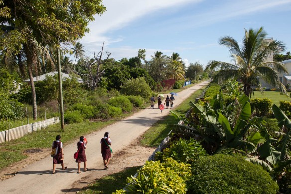 Students walking to school in Pangai under the heat of the morning sun 